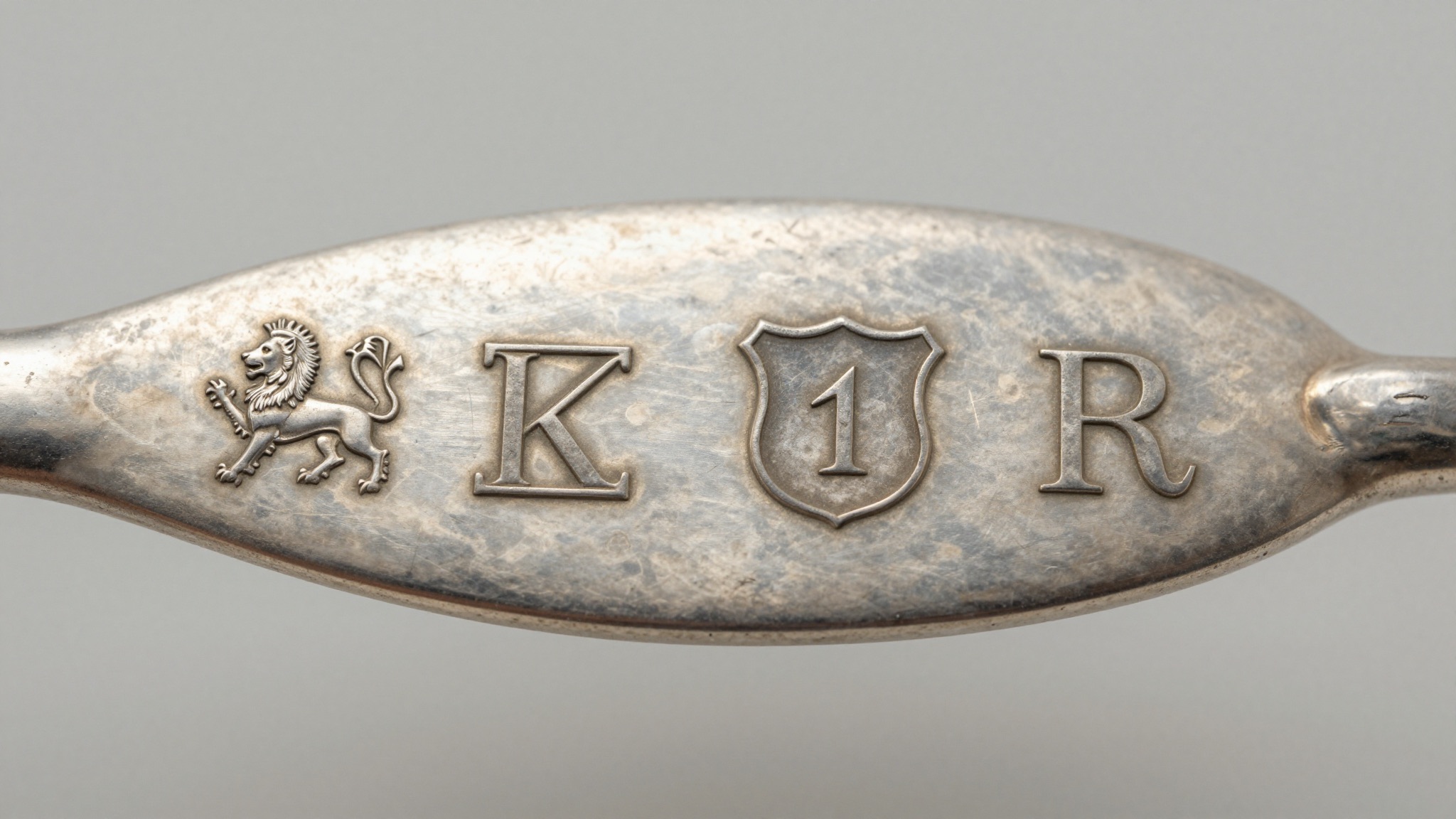 Four hallmarks on sterling silver: lion passant, town mark, date letter, and maker's mark
