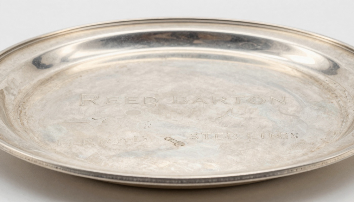Reed & Barton sterling silver mark with STERLING stamp and date symbol on the base of a tray