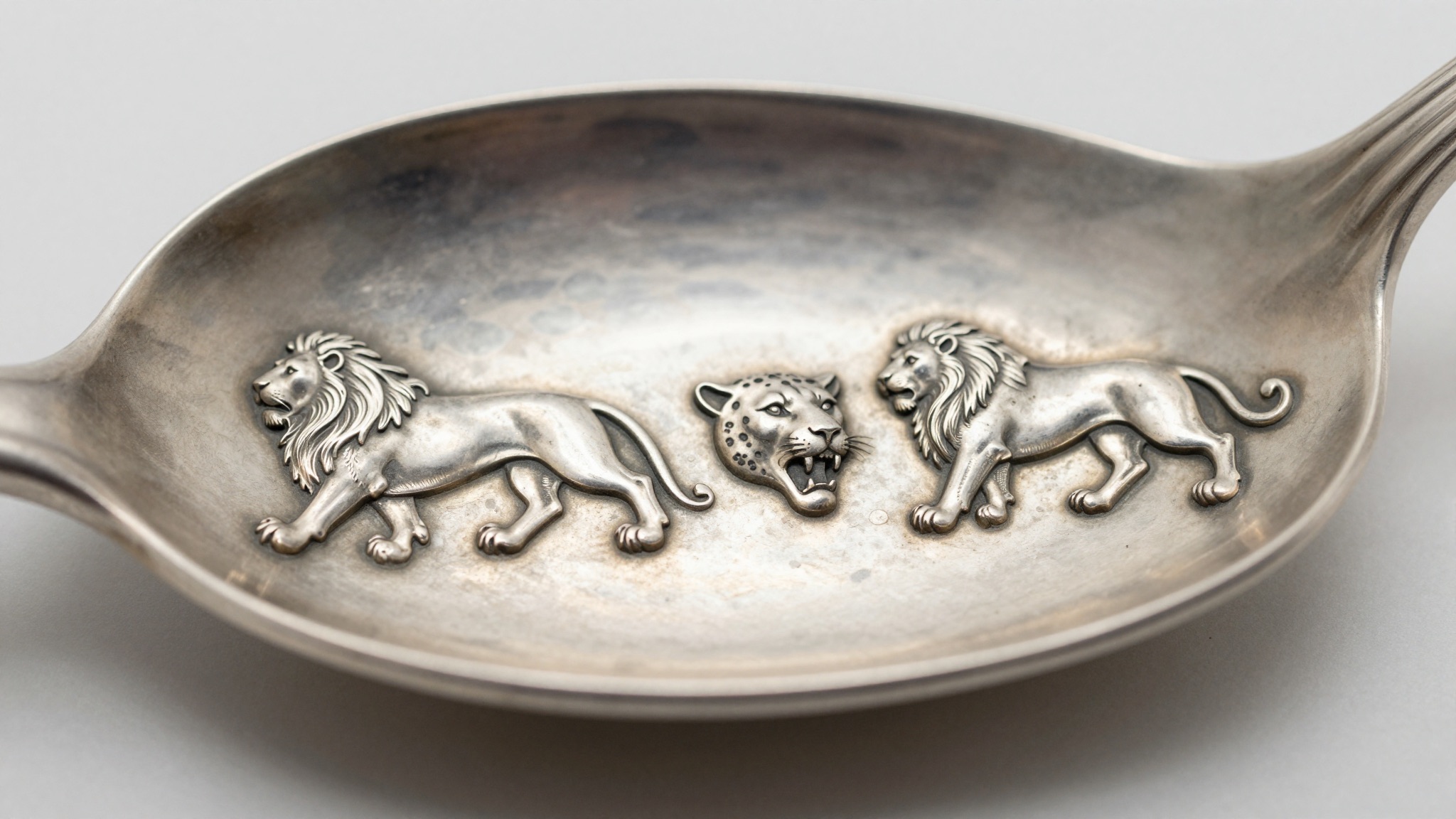 Row of antique silver assay marks and a date letter struck on sterling